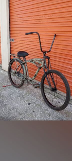 Custom camo-painted cruiser with ape hangers