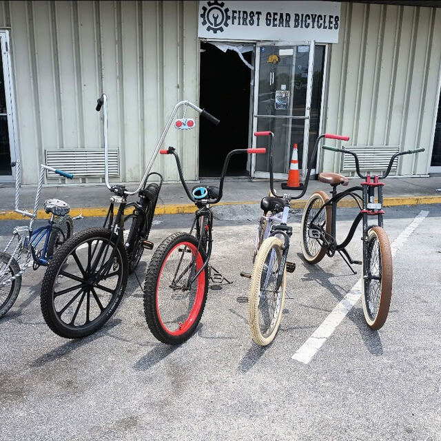Four finished custom bikes lined up in the lot