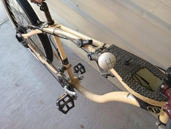 Pool-ball shifter knob and drivetrain detail on a cream custom build