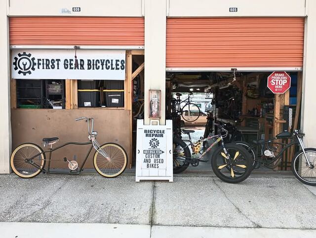 First Gear Bicycles storefront with the roll-up door open and bikes out front