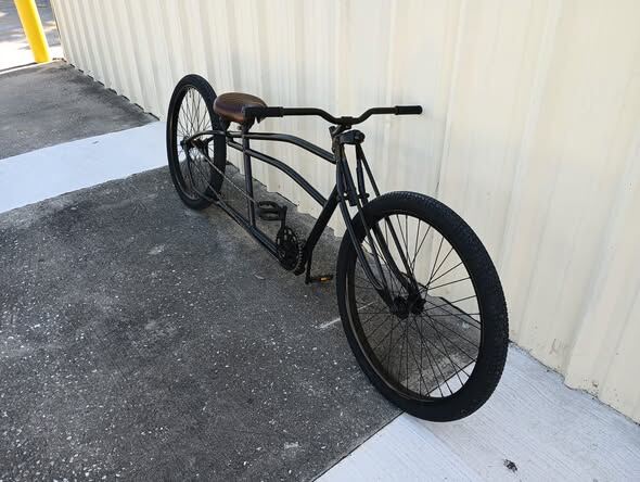 Hand-built black stretch tandem, front three-quarter view