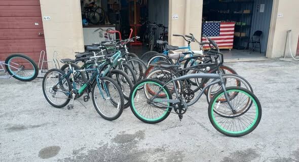 A lineup of refurbished used bikes in front of the shop